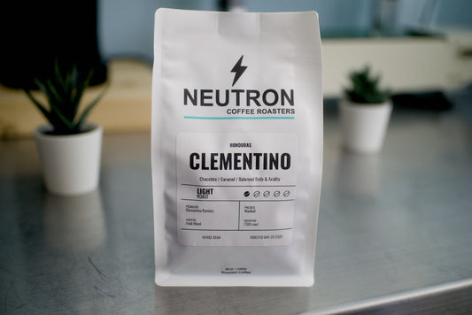 Neutron Coffee Roasters Clementino coffee bag on a metal surface with a blurred background.